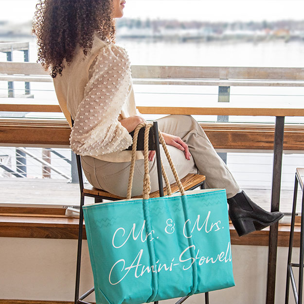 Custom Guestbook Tote hanging on chair in coffee shop