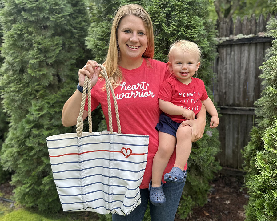 Brylie Young holding daughter and Sea Bags Heart Tote