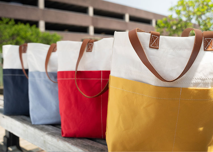 Lineup of Chebeague Market Totes in Navy, Blue, Red and Yellow