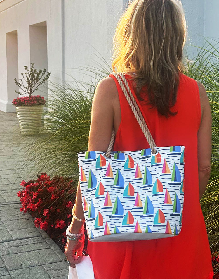 Woman walking carrying Full Sail Essential Handbag