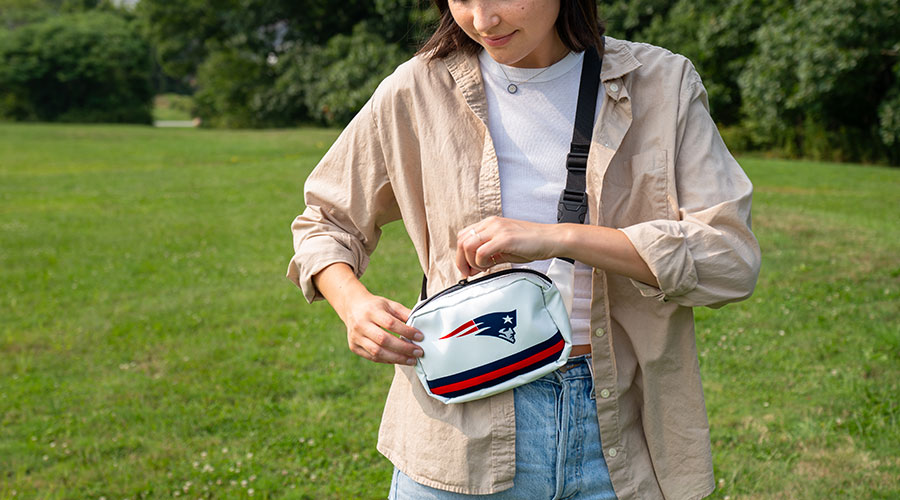 Woman unzipping New England Patriots Belt Bag