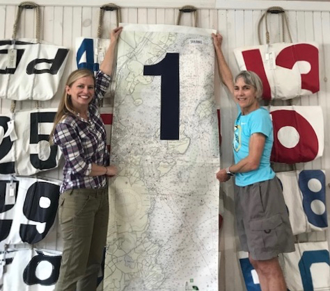 Sea Bags' staff show off the recycled sail cloth mile marker to Joan Benoit Samuelson