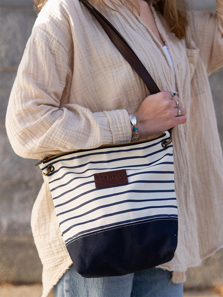 Woman wearing New Navy Stripe Chebeague Crossbody Bag over the shoulder