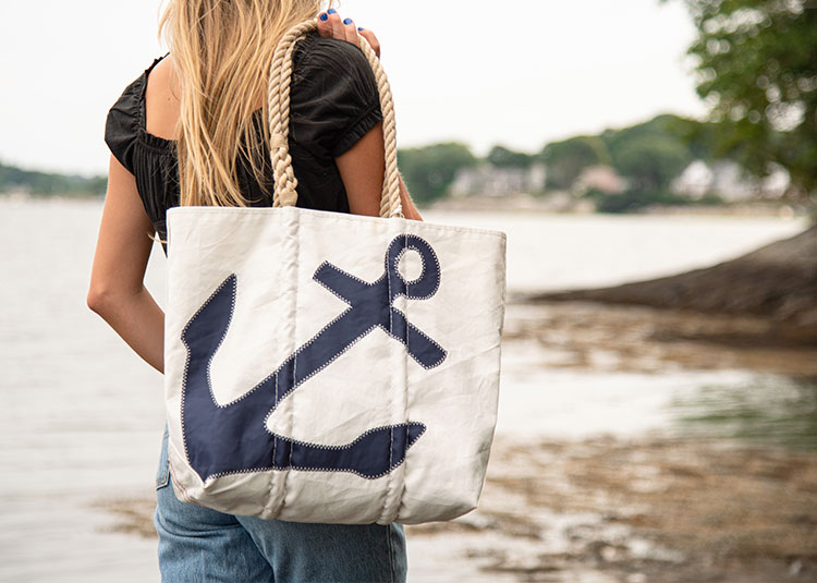 Woman carrying Navy Anchor Tote along coast