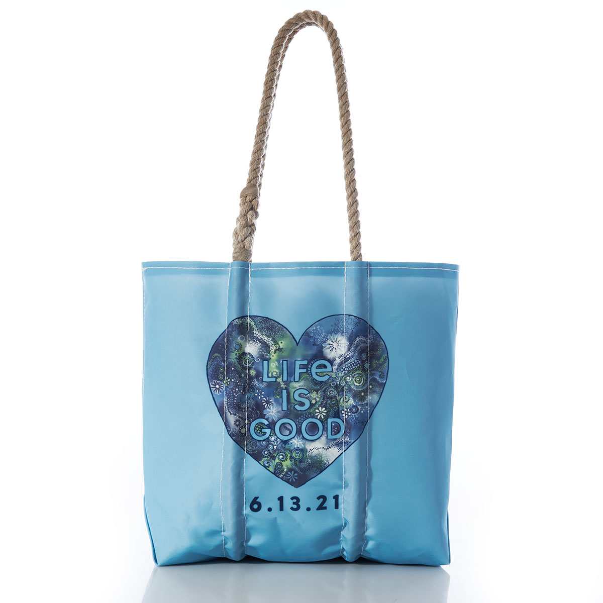 a bright blue recycled sail cloth tote with hemp rope handles is printed with a heart shape filled with whimsical underwater shapes and textures. a customizable date and the life is good brand name sit under the heart