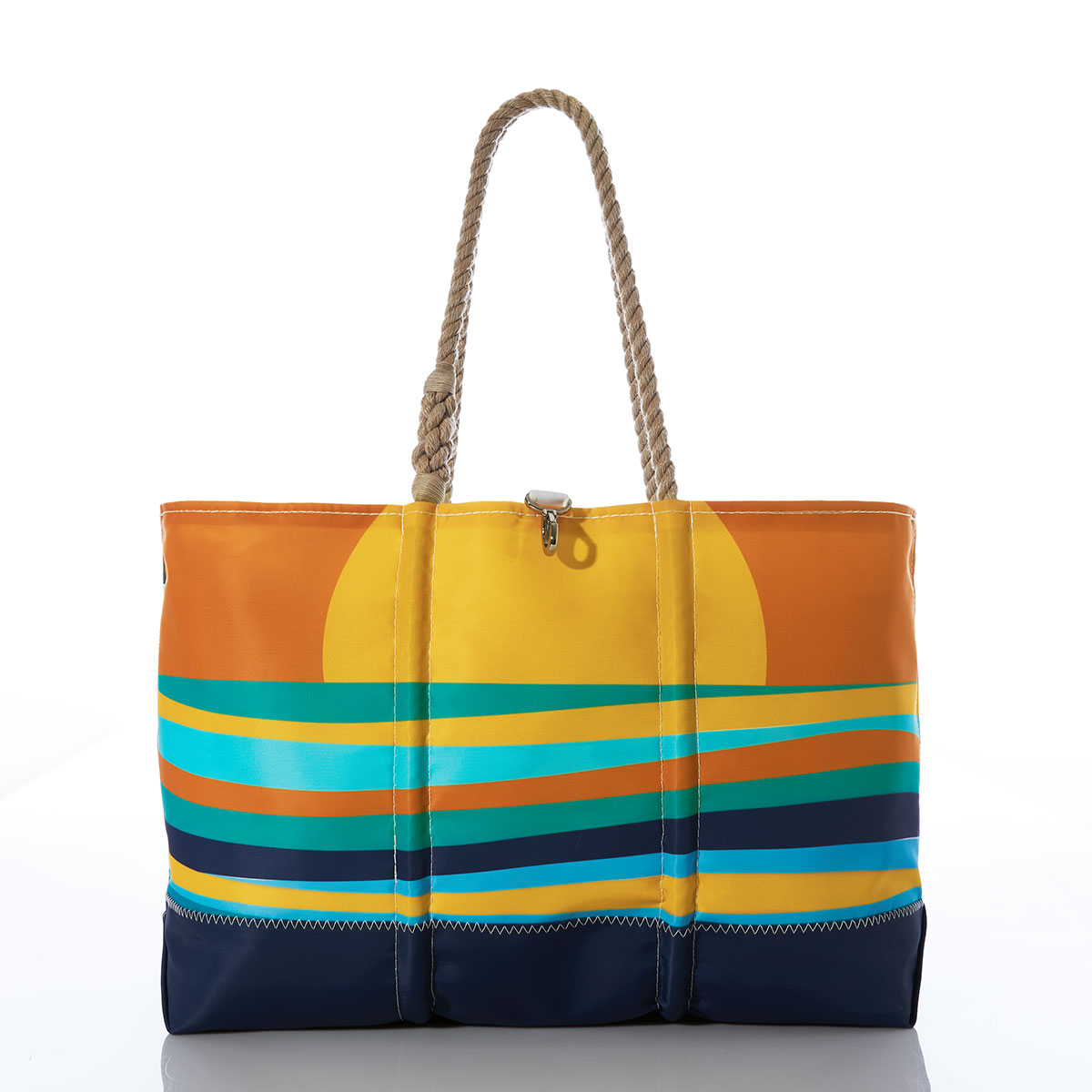multicolor wavy ocean stripes sit under a rising sun printed on a recycled sail cloth tote with hemp rope handles