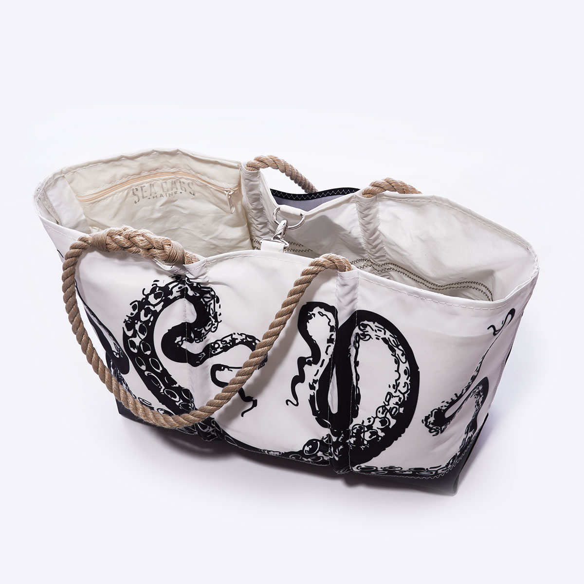 clasp closure: black legs of an octopus reach up to the top of this recycled sail cloth tote, with a solid black along the bottom, and hemp rope handles