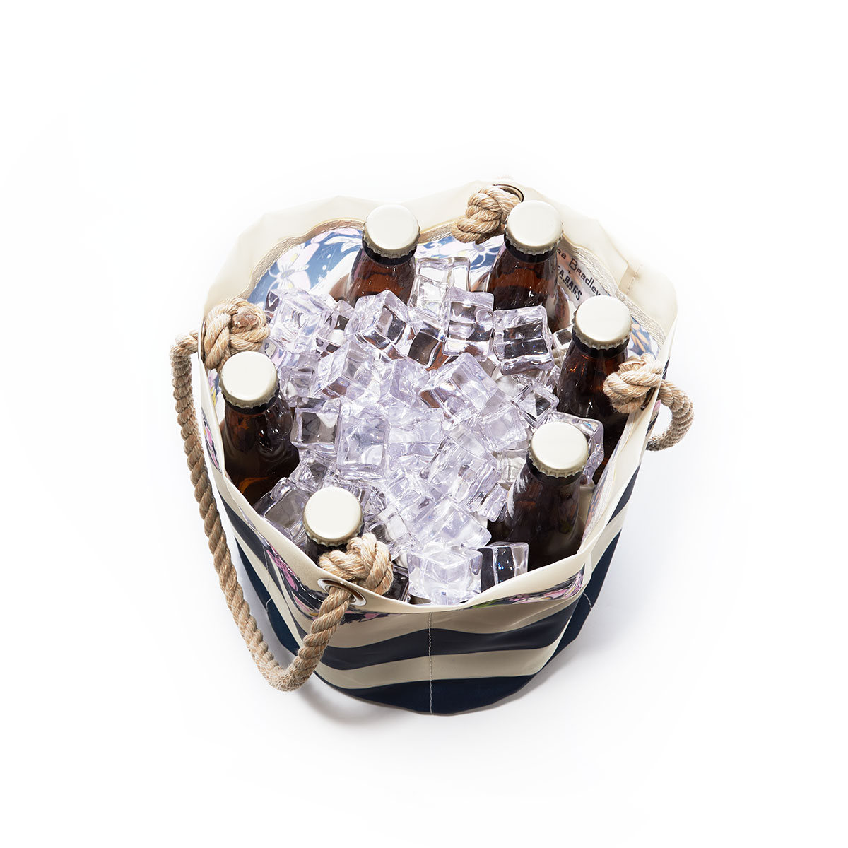 inside view of bottles and ice in a bold navy and white striped recycled sail cloth beverage bucket with hemp rope handles embellished with flowers around the top