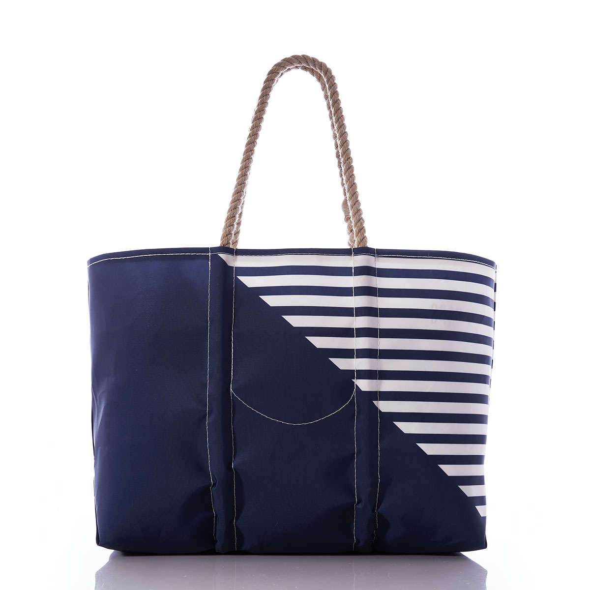  back view of the breton stripe white anchor totes are embellished with a white anchor in front of a solid navy bottom corner and a navy and white striped top corner and hemp rope handles