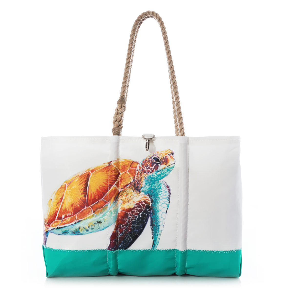 a white recycled sail cloth beach tote with hemp rope handles and a teal wraparound back pocket is printed with a bright friendly multicolor sea turtle