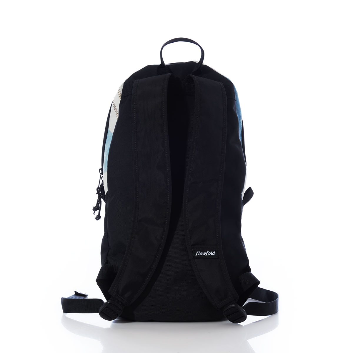 back view of a backpack with a black canvas base, straps, and front zipper with blue and white recycled sail cloth