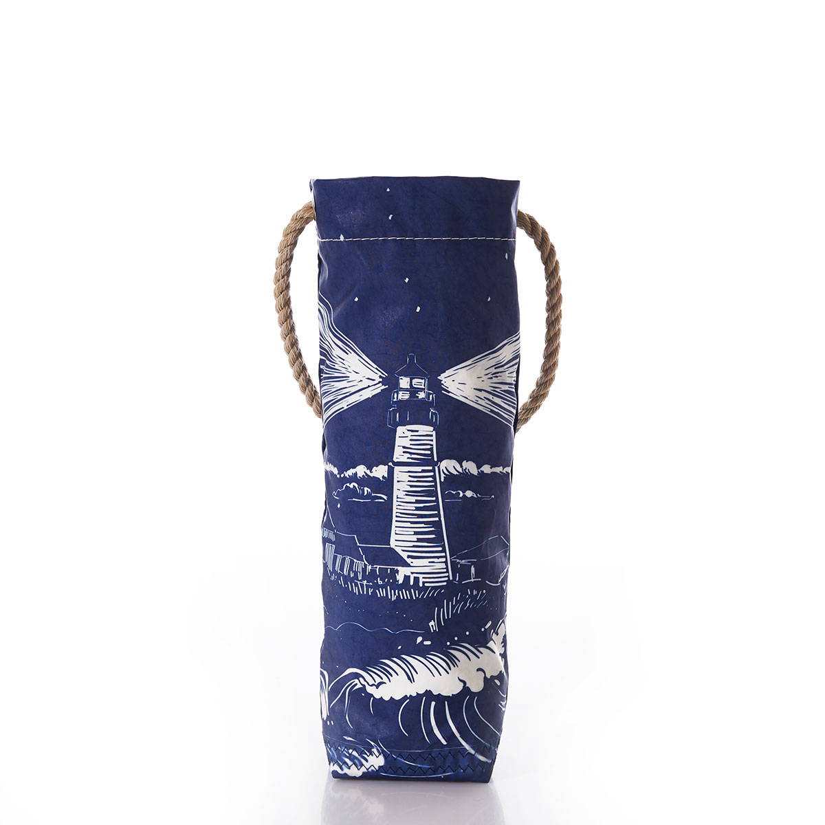 a recycled sail cloth wine bag with a hemp rope handle is printed with a navy background and a white image of a lighthouse on a coastal rock with waves crashing and the light beaming through the dark