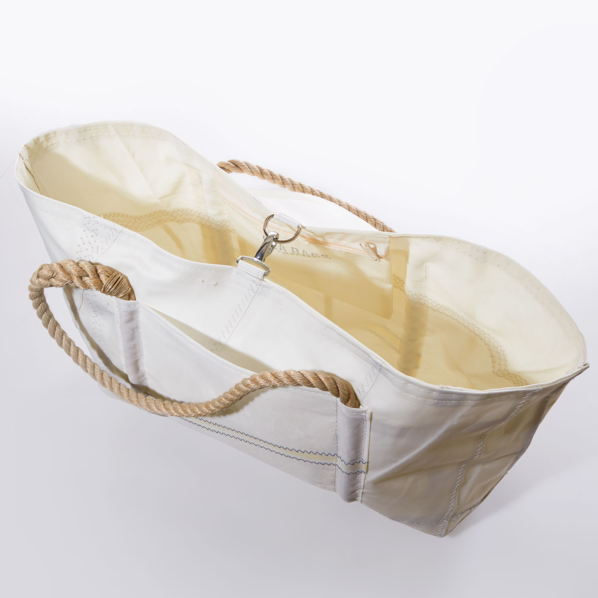 clasp closure of white recycled sail cloth tote with hemp rope handles