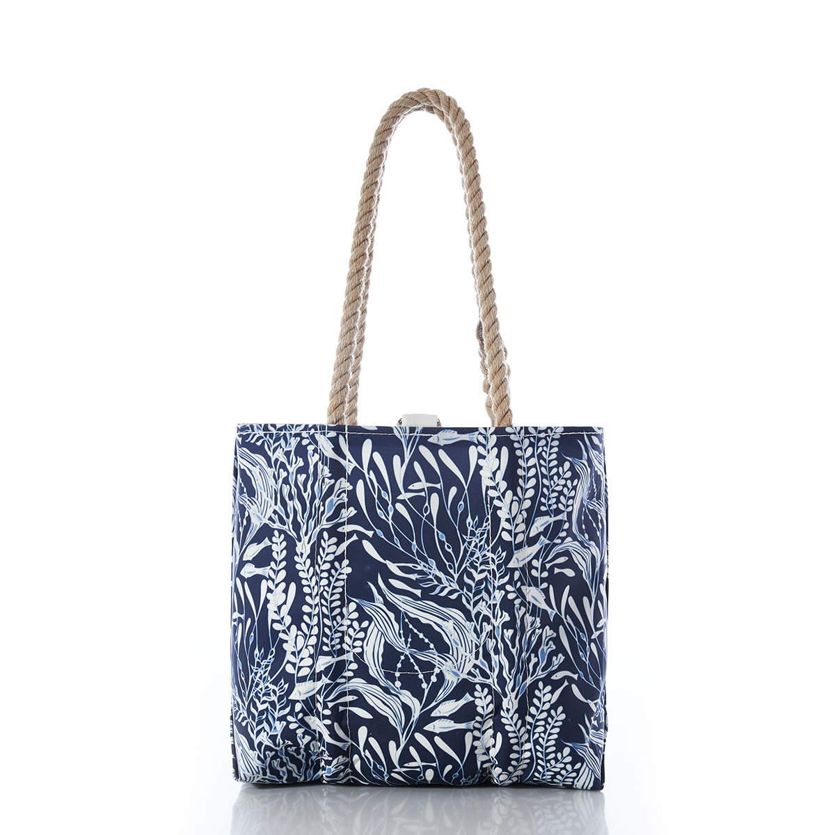little fish swim among various types of seaweed in shades of navy and white on a recycled sail cloth handbag with hemp rope handles, back view