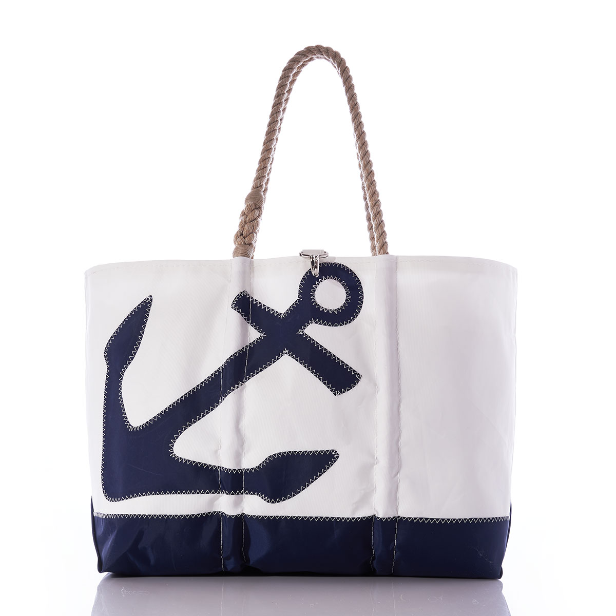 a navy anchor sits left of center on a white recycled sail cloth tote with a navy bottom and hemp rope handles