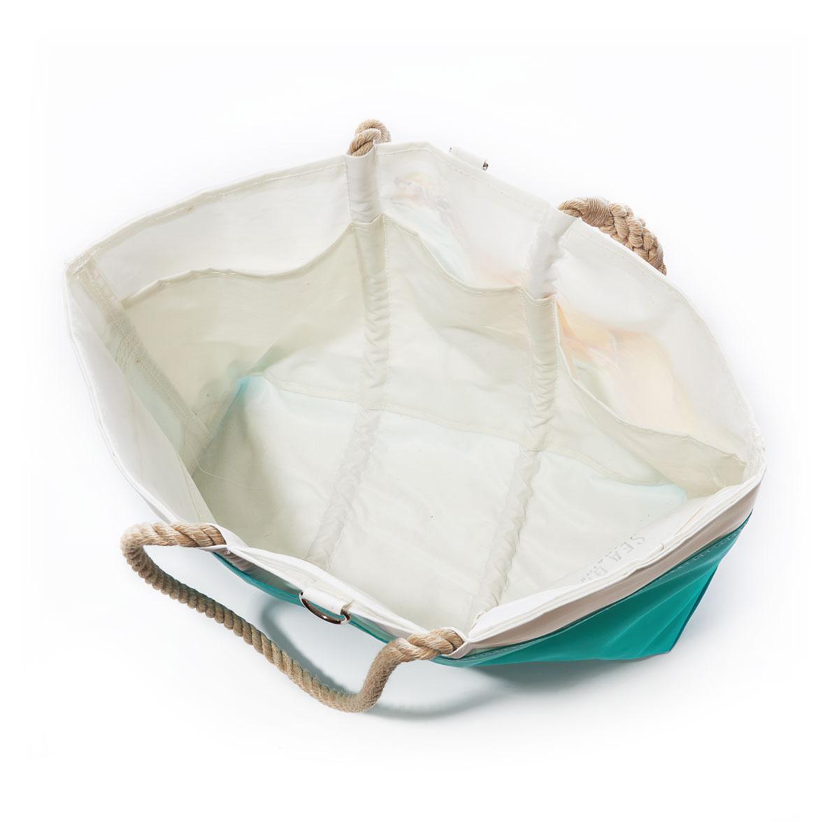 inside view of three interior pocket ina white recycled sail cloth beach tote with hemp rope handles and a teal wraparound back pocket is printed with a bright friendly multicolor sea turtle
