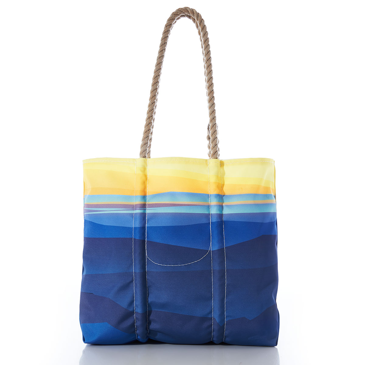 back view of a recycled sail cloth medium tote with hemp rope handles printed with a landscape of a yellow sunrise over blue mountains and water