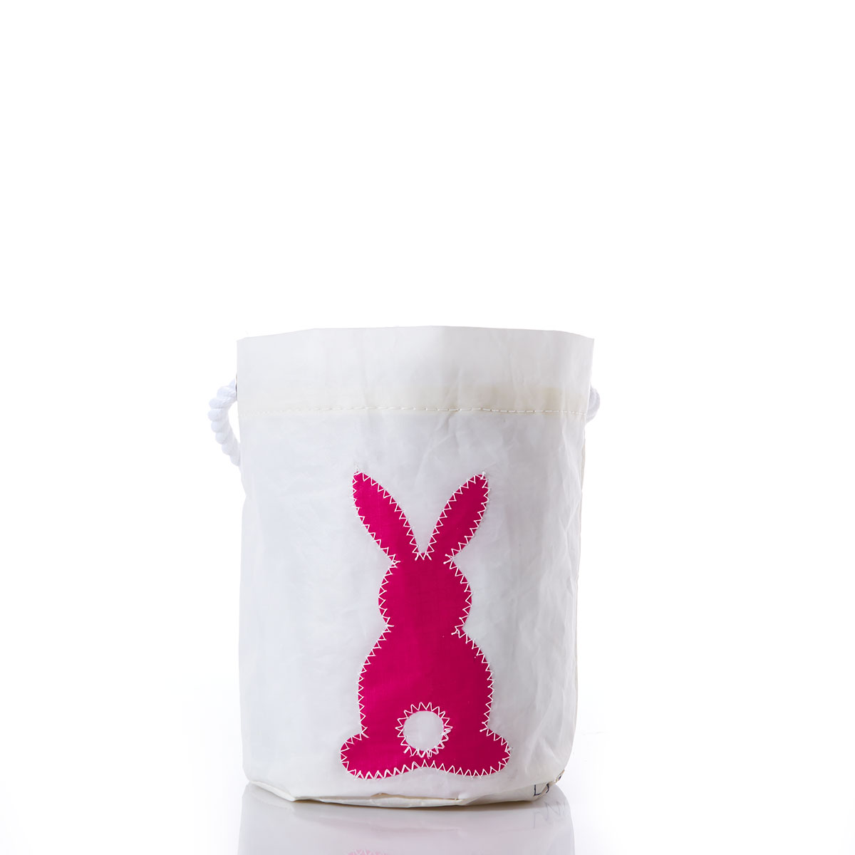 a bright pink silhouette of bunny with a white circle tail on a white recycled sail cloth bucket bag with a white rope handle