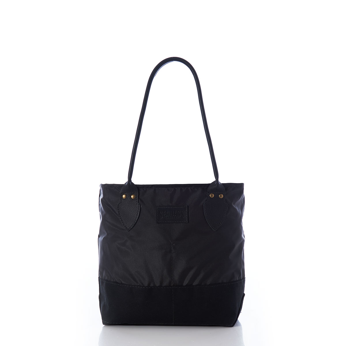front view of a black recycled sail cloth handbag with a black canvas bottom and leather handles