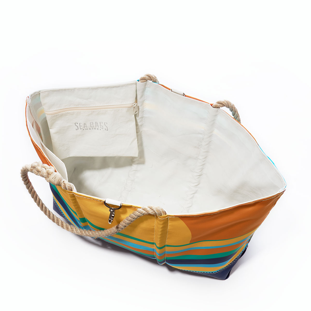 inside view of a tote with multicolor wavy ocean stripes sit under a rising sun printed on a recycled sail cloth tote with hemp rope handles