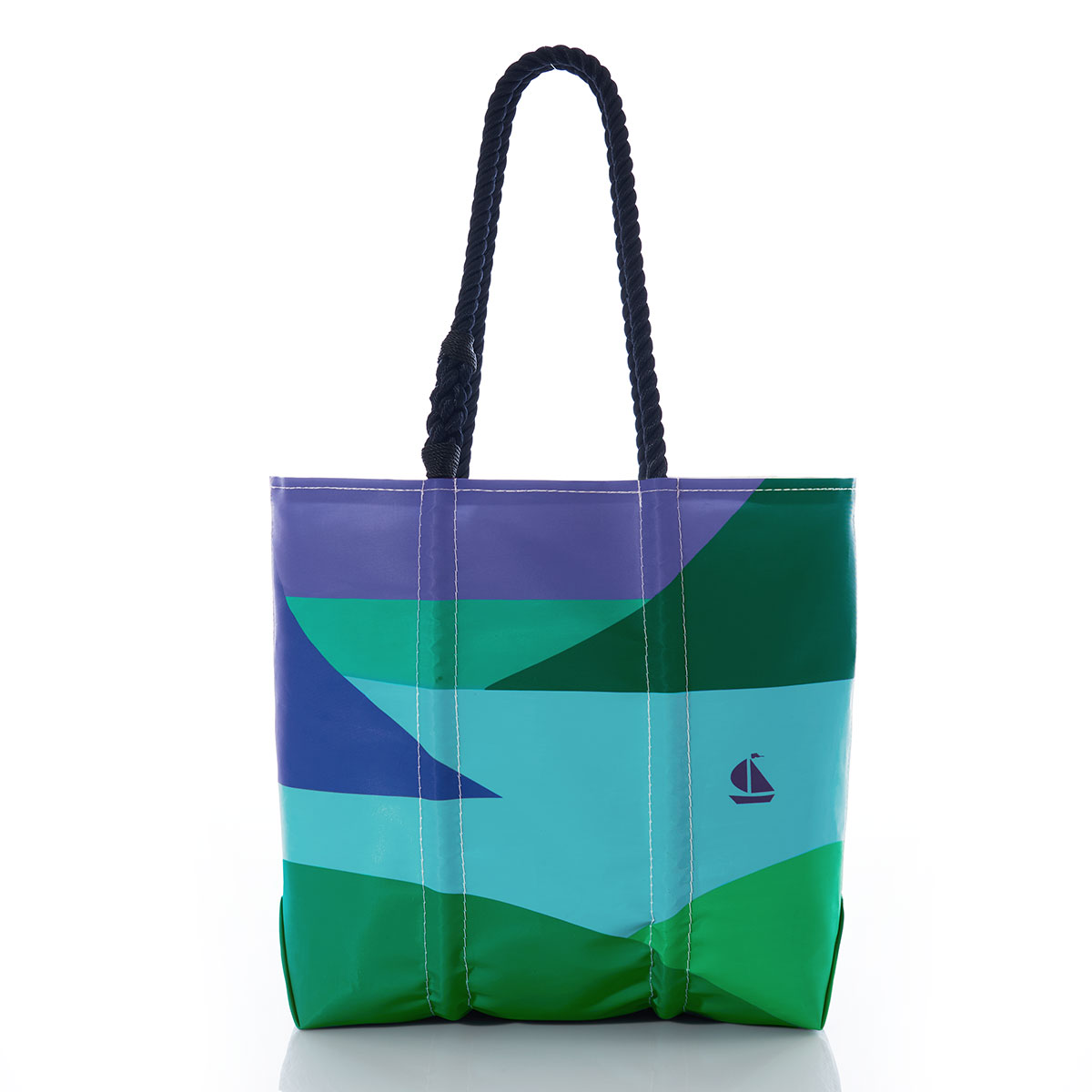 a geometric landscape of blue water and green and navy mountains with a lone blue sailboat printed on a recycled sail cloth tote with hemp rope handles