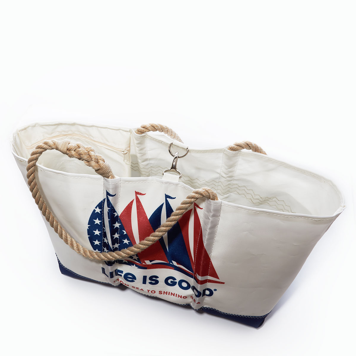 clasp closure of four sailboats in patriotic red and blue printed on white recycled sail cloth beach tote with navy bottom and hemp rope handles