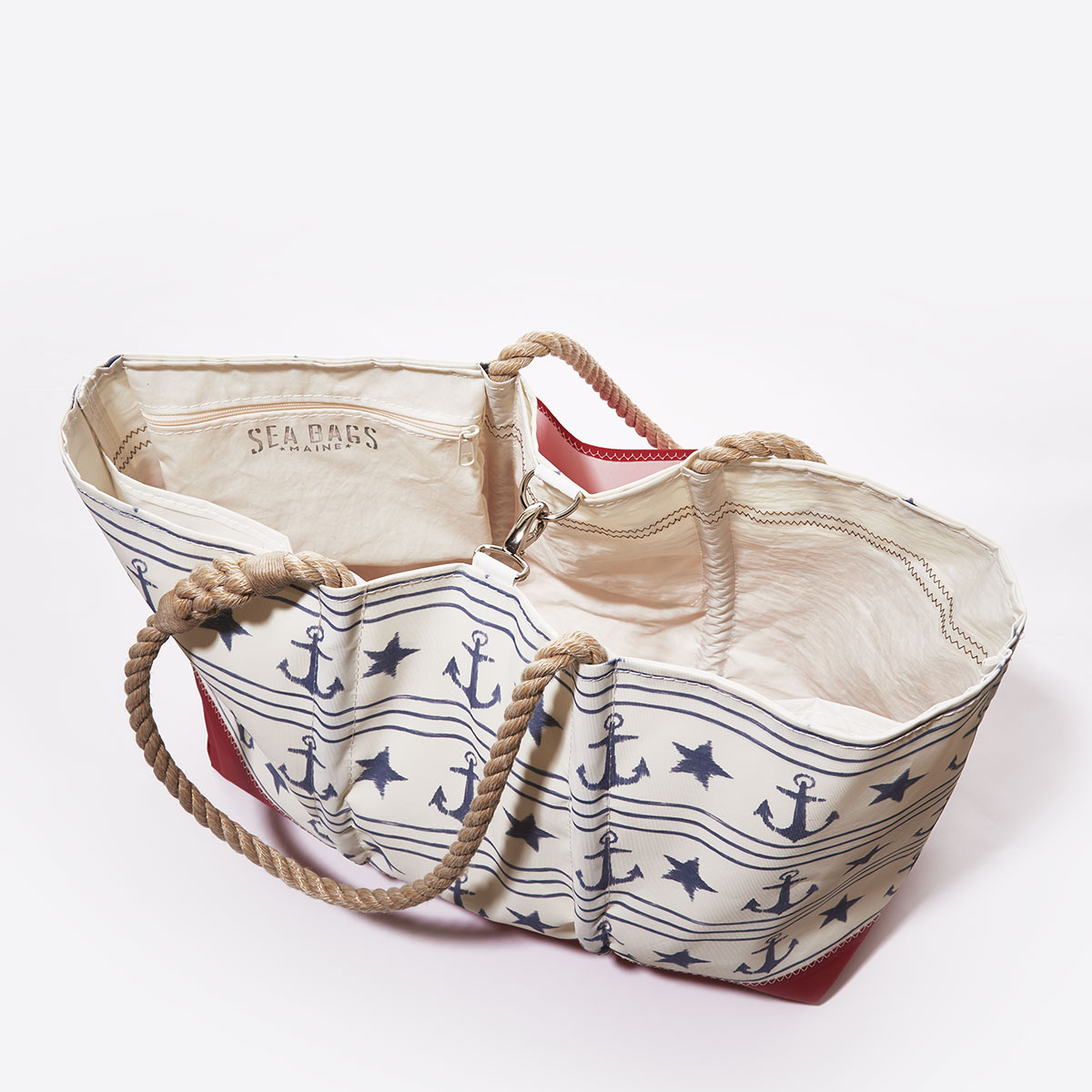 clasp closure, blue anchors stars and stripes line this recycled sail cloth tote with a red bottom and hemp rope handles