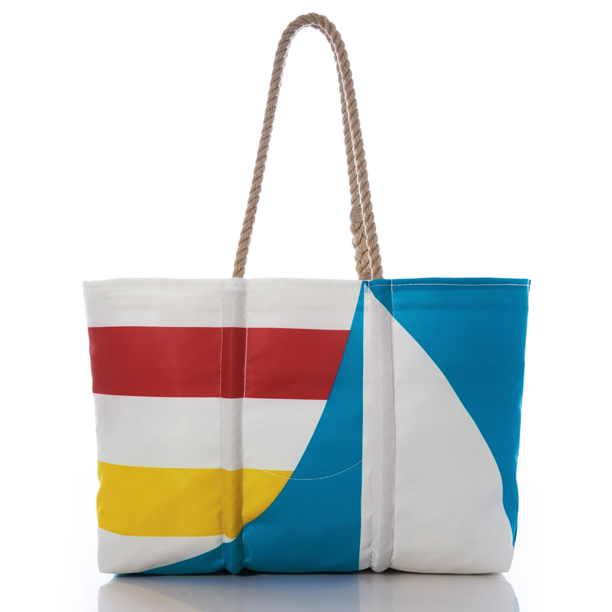 a recycled sail cloth tote with hemp rope handles is printed with a blue graphic sailboat and bold yellow and red stripes 