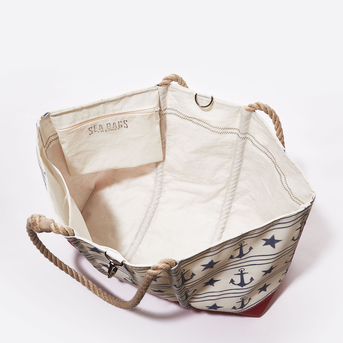 inside view, blue anchors stars and stripes line this recycled sail cloth tote with a red bottom and hemp rope handles