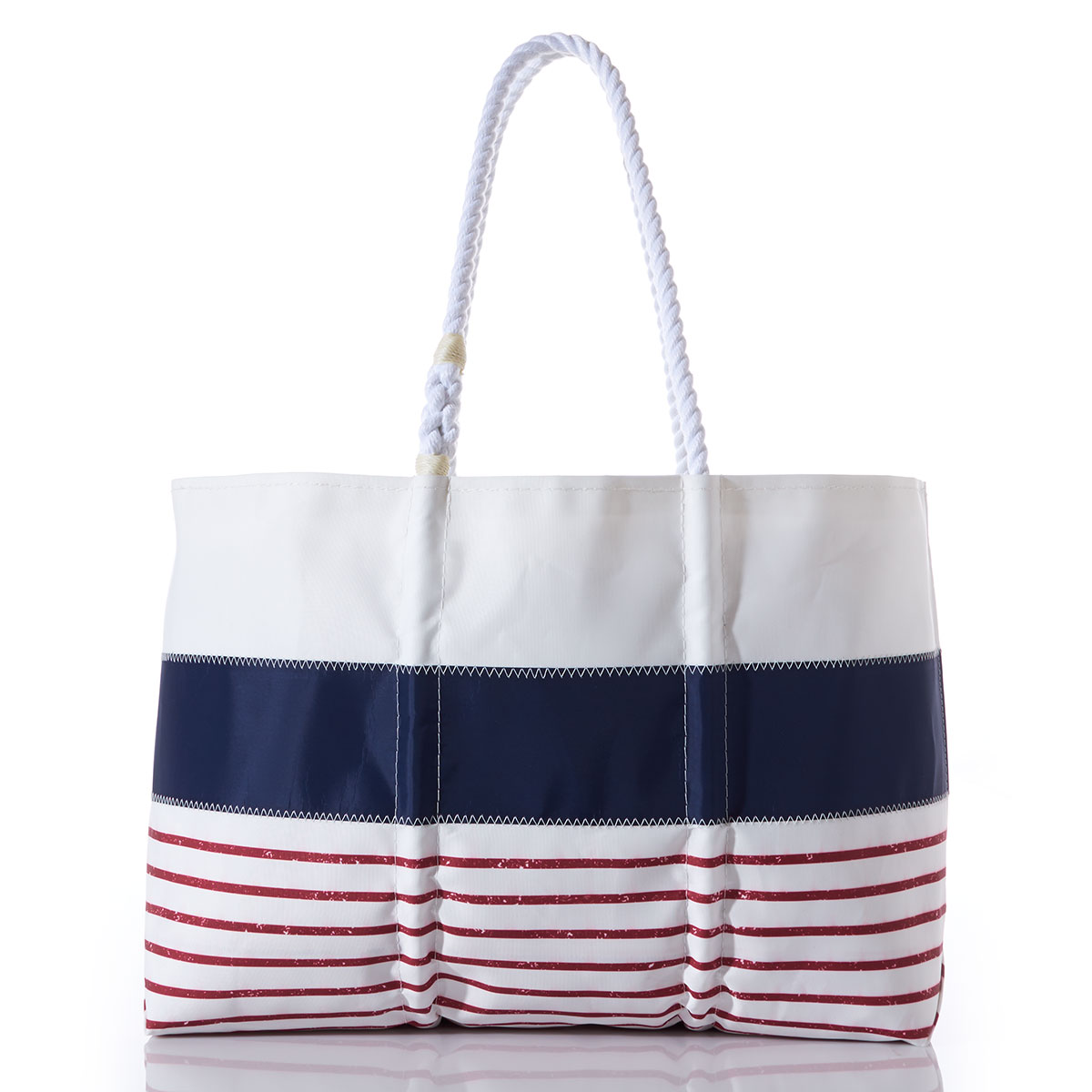 recycled sail cloth tote with a solid white stripe on top of a solid blue stripe on top of red and white stripes and white rope handles