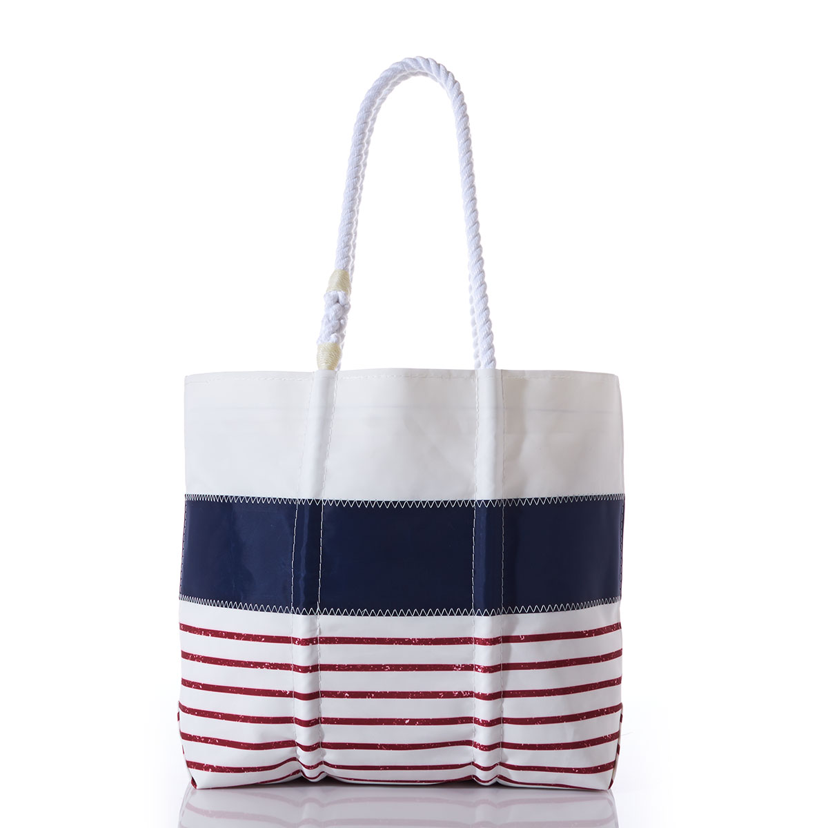 recycled sail cloth tote with a solid white stripe on top of a solid blue stripe on top of red and white stripes and white rope handles