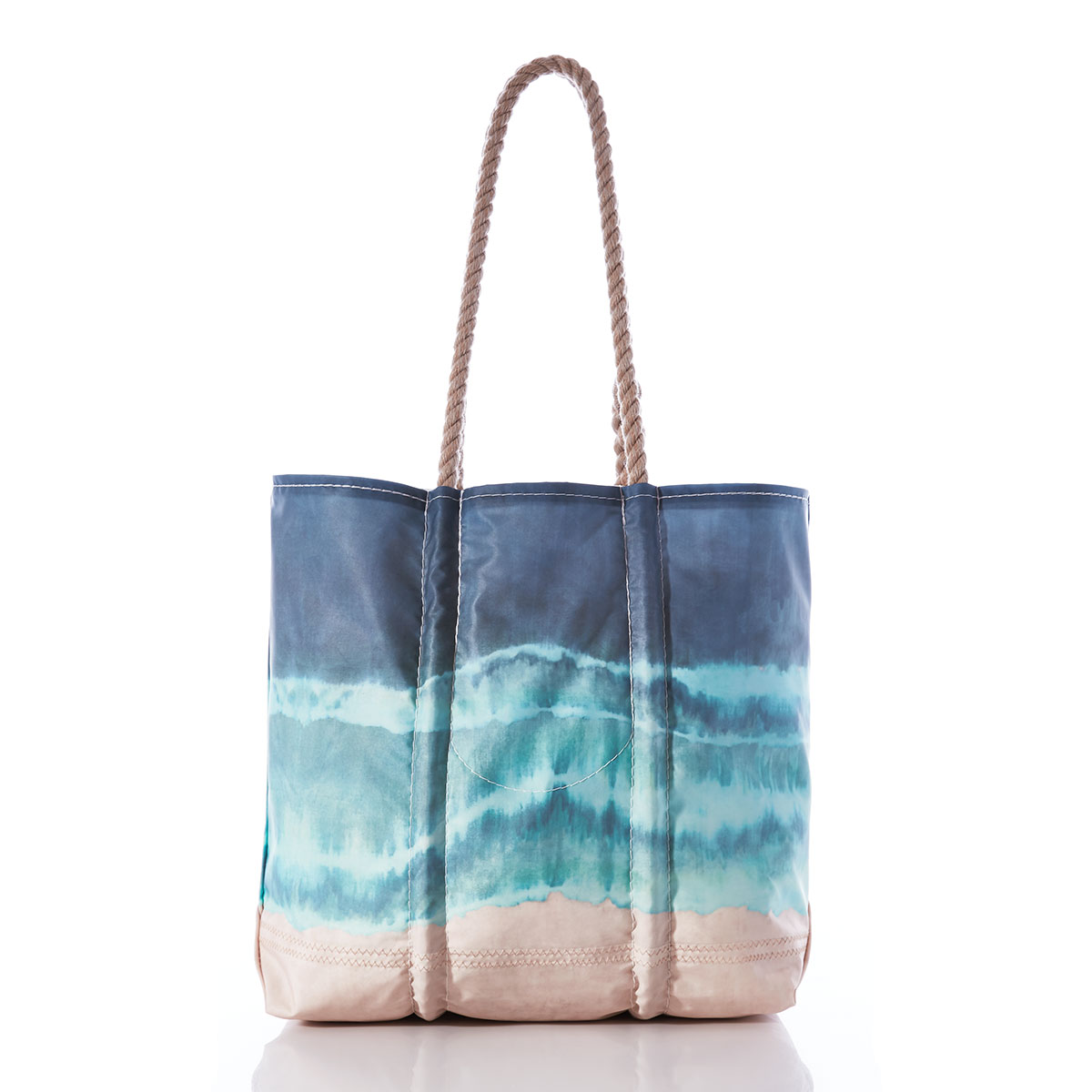 a recycled sail cloth tote with hemp rope handles is printed in naturally formed stripes with a bottom tan, middle light blue, and top dark blue 