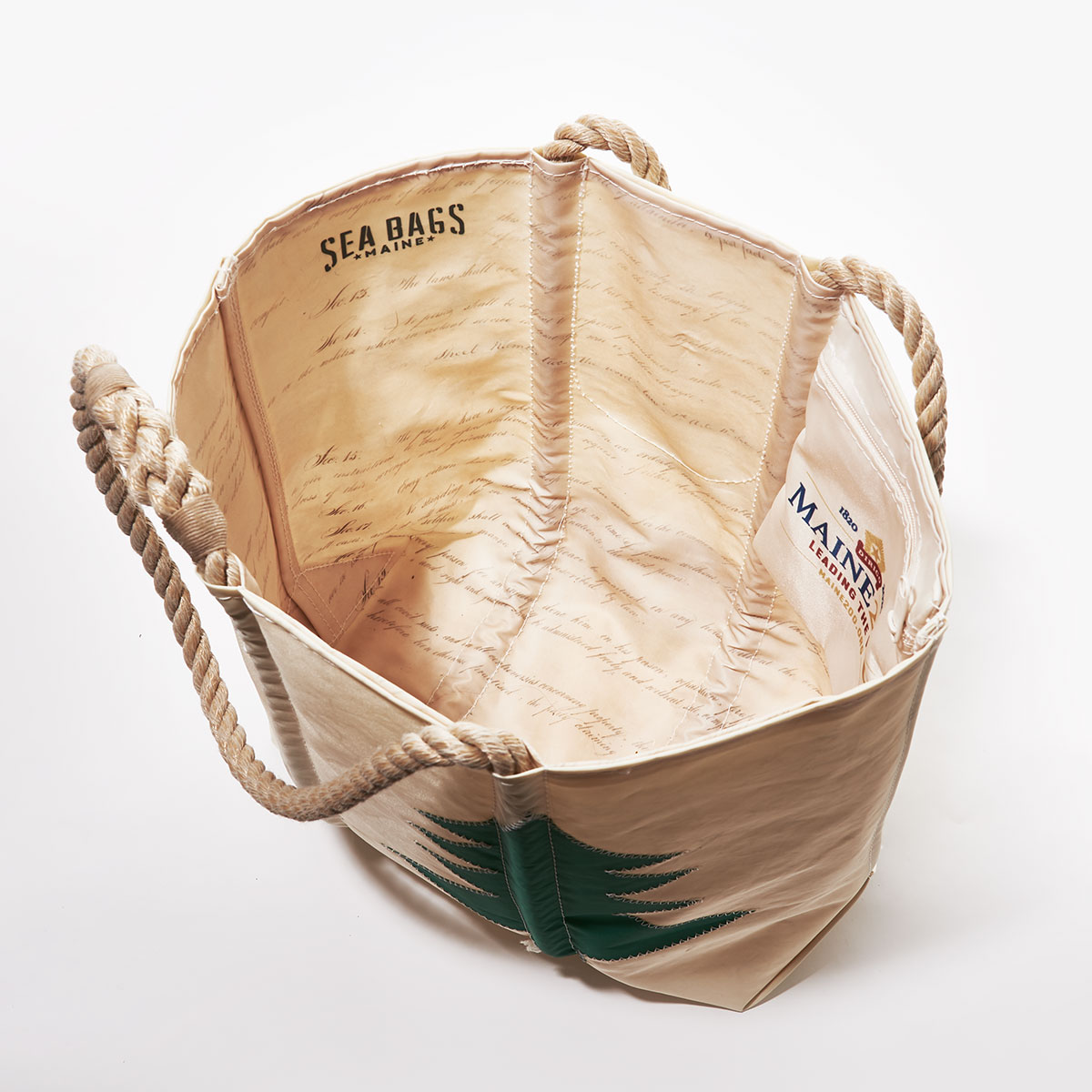inside view of written constitution on liner of recycled sail cloth tote featuring a navy star and green pine tree from Maine's original state flag, with hemp rope handles