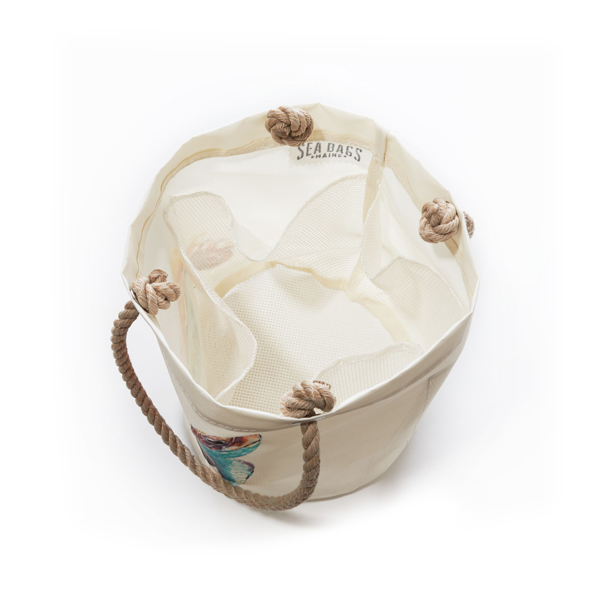 inside view showing mesh bottom and four mesh pockets, a bright friendly multicolor sea turtle is printed on a white recycled sail cloth beachcomber bucket bag with hemp rope handles
