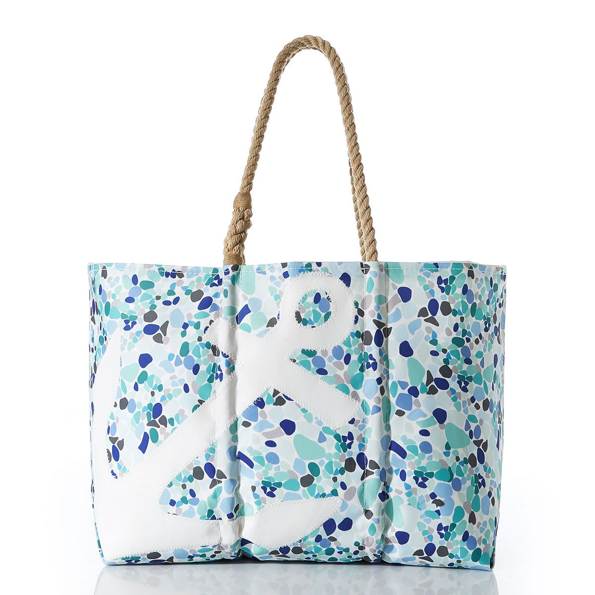 a white anchor sits on the front of a recycled sail cloth tote covered in a sea glass print of varied blues, with hemp rope handles