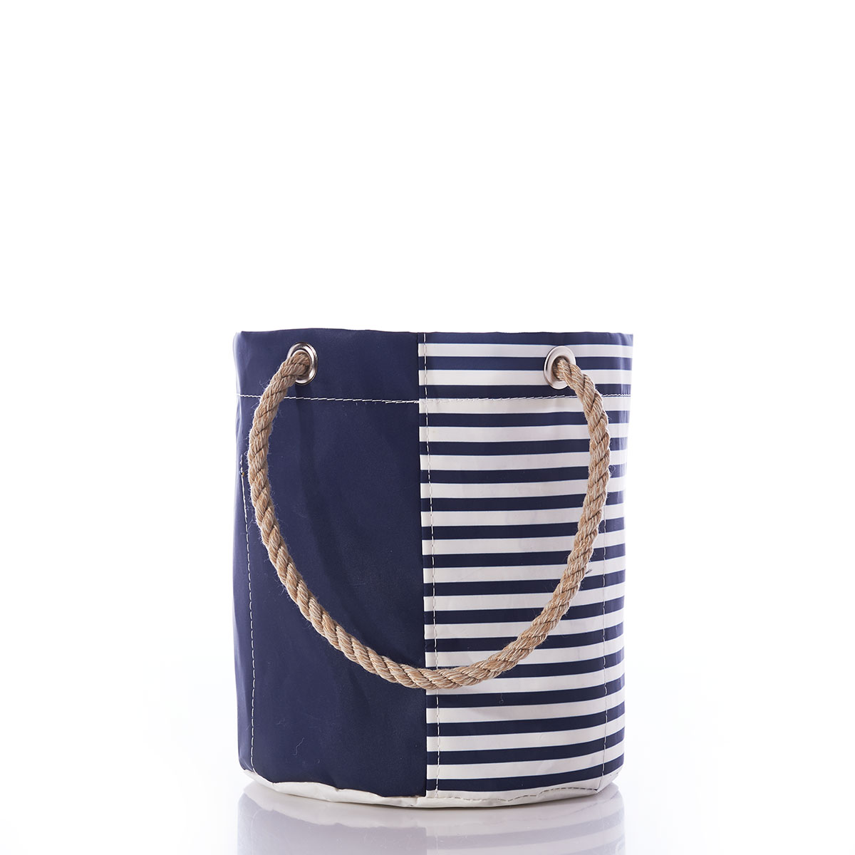 side view: the breton stripe white anchor beverage bucket is embellished with a white anchor in front of a solid navy bottom corner and a navy and white striped top corner and navy rope handles