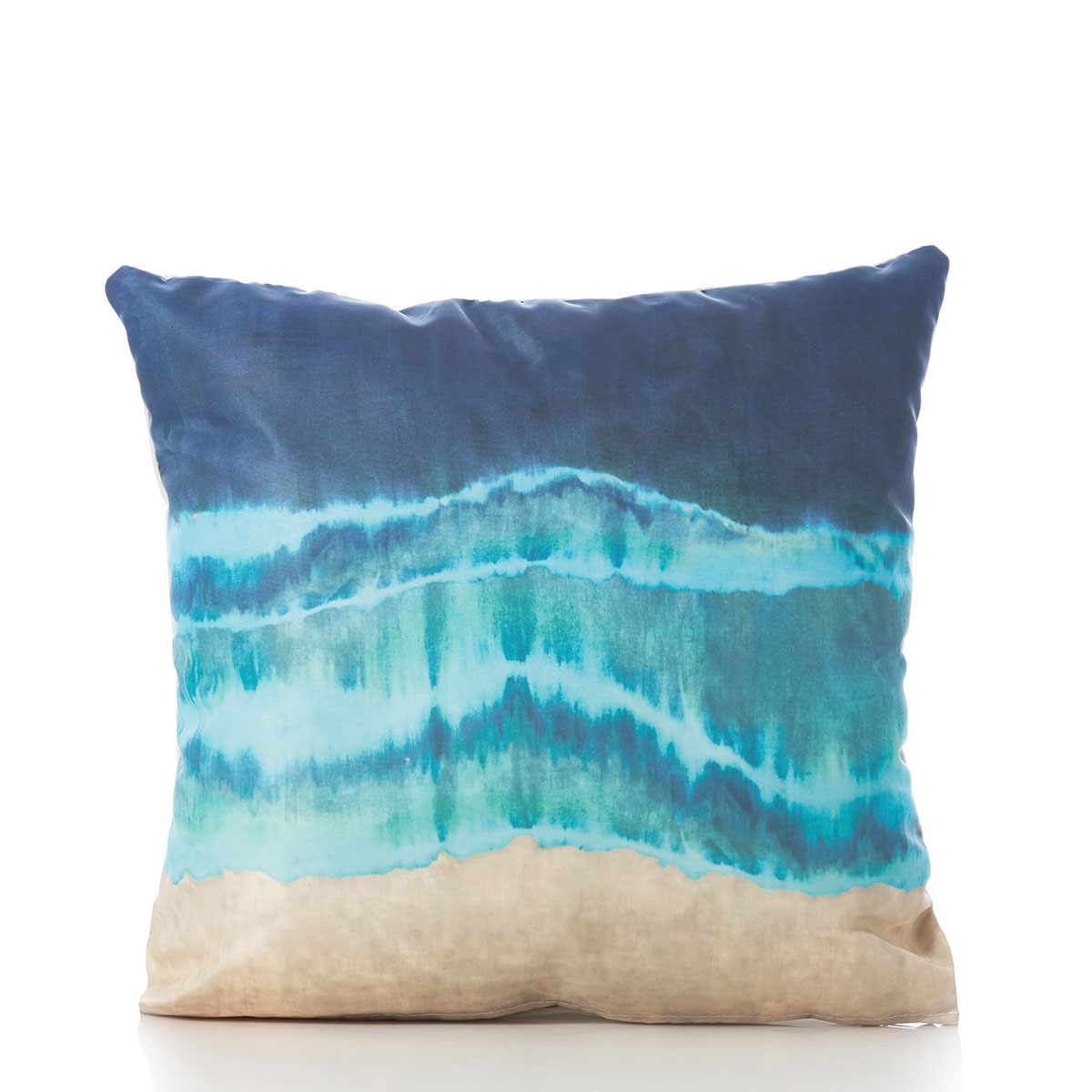 a recycled sail cloth pillow is printed with stripes of tan, teal, and blue depicting waves washing onshore