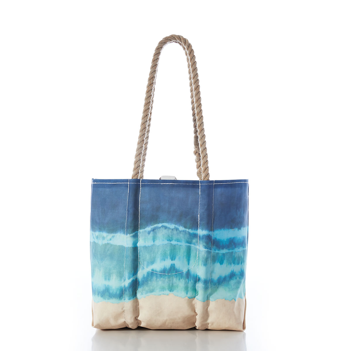 a recycled sail cloth handbag with hemp rope handles is printed in naturally formed stripes with a bottom tan, middle light blue, and top dark blue 