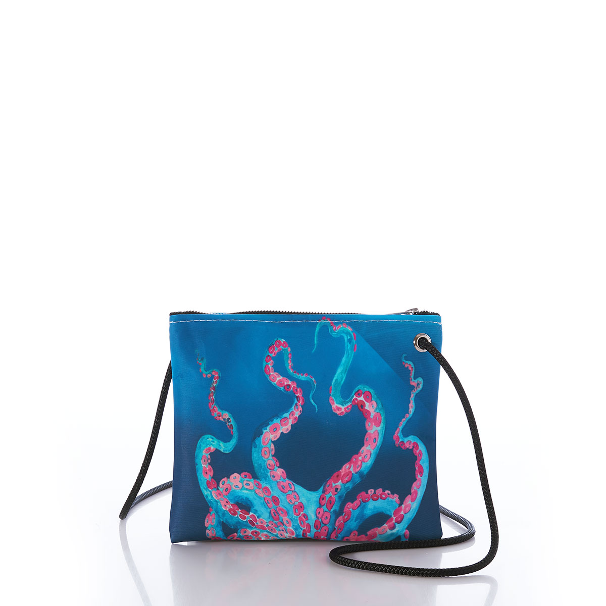 a colorful bioluminescent octopus in blue with pink tentacles stretches its legs up the the top of a blue recycled sail cloth crossbody with a tan braided dock line rope