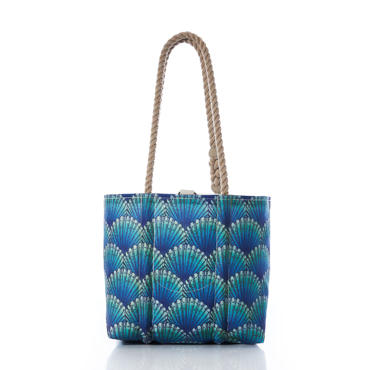 back view of a recycled sail cloth handbag with hemp rope handles is printed with a repeating pattern of blue scallop shells