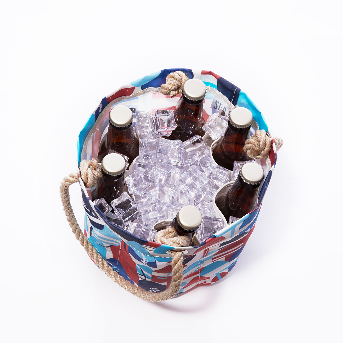 inside view with bottles and ice: a recycled sail cloth beverage bucket bag with hemp rope handles is emblazoned with a variety of printed buoys in reds and blues in different shapes and sizes