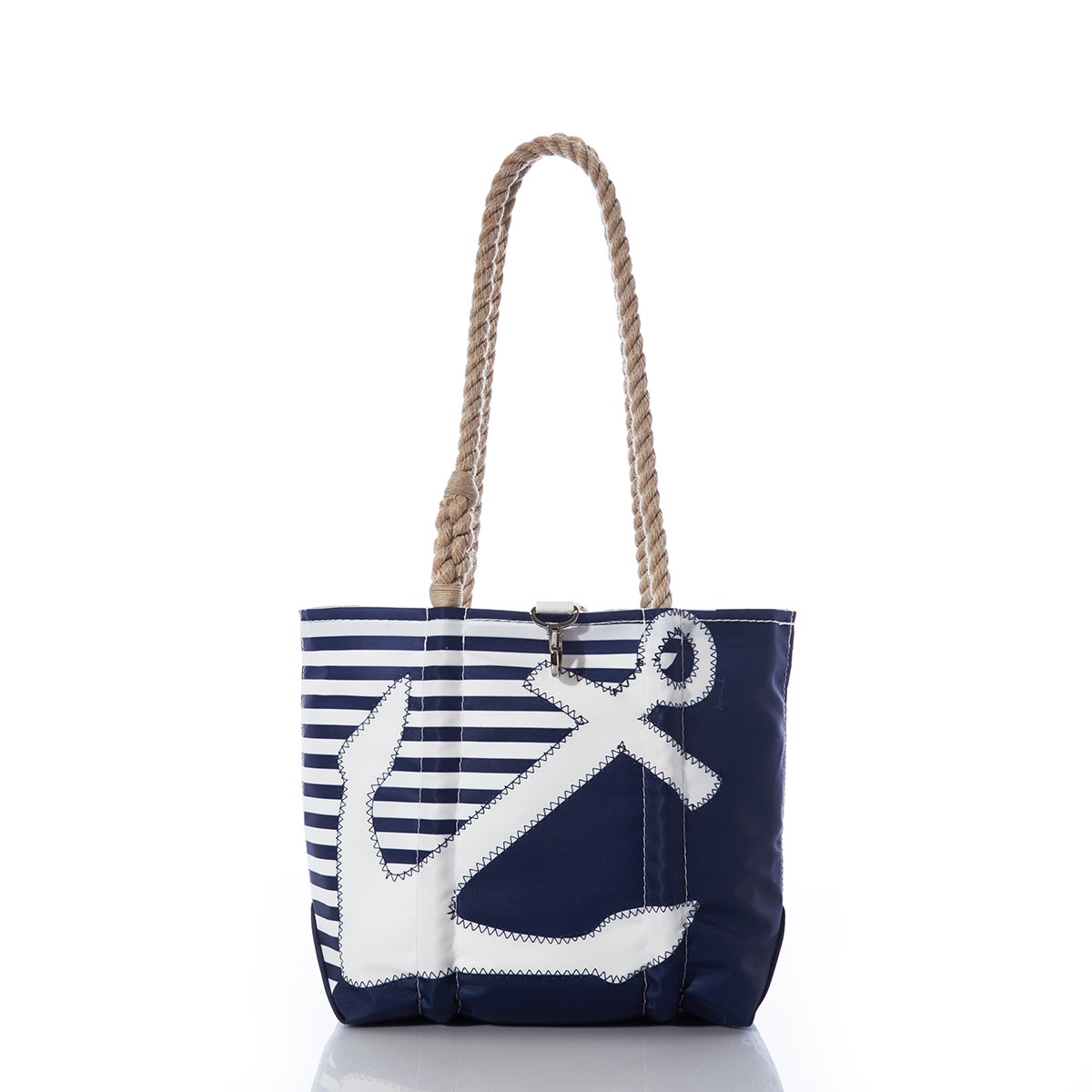 a white anchor divides a solid navy blue bottom right triangle and a navy and white striped top left triangle, printed on a recycled sail cloth tote with hemp rope handles