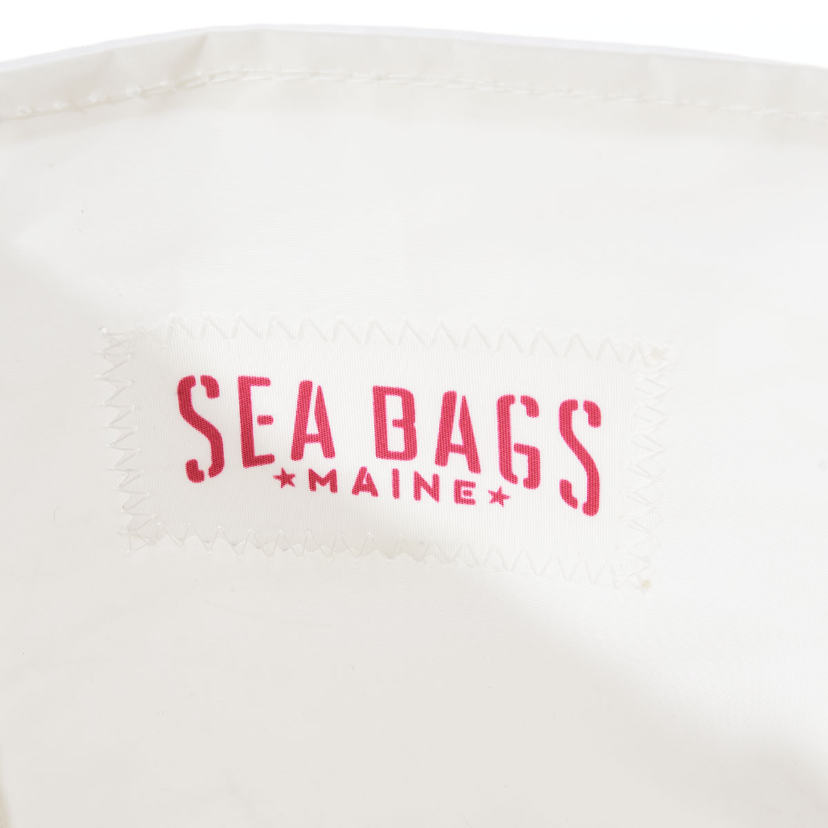 close up of pink Sea Bags logo