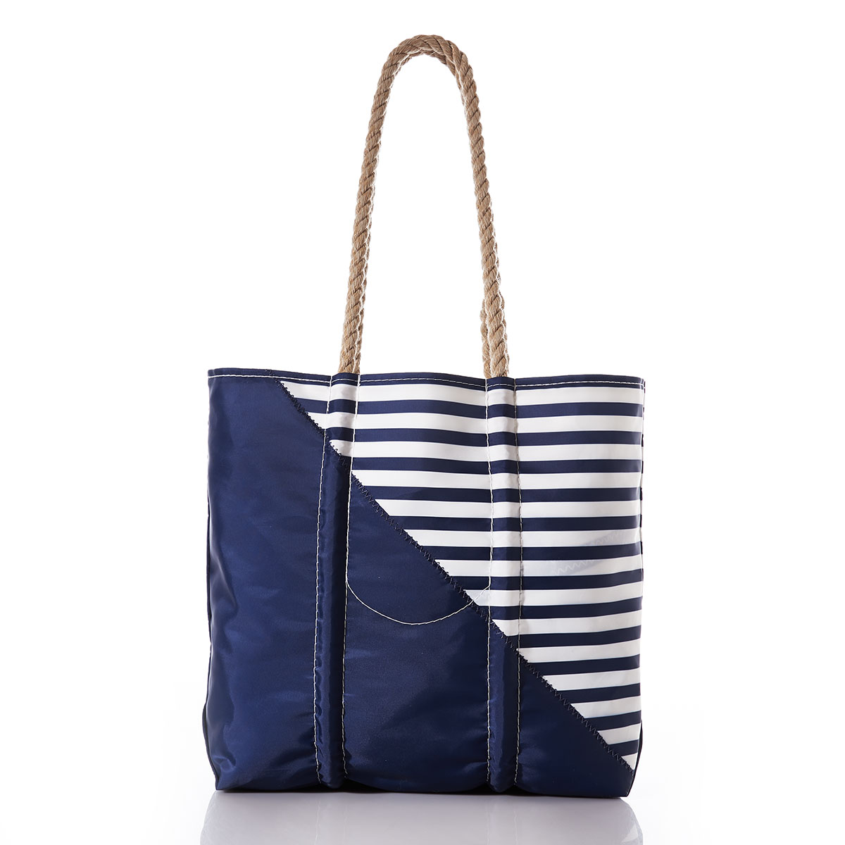 back view of the breton stripe white anchor totes are embellished with a white anchor in front of a solid navy bottom corner and a navy and white striped top corner and hemp rope handles