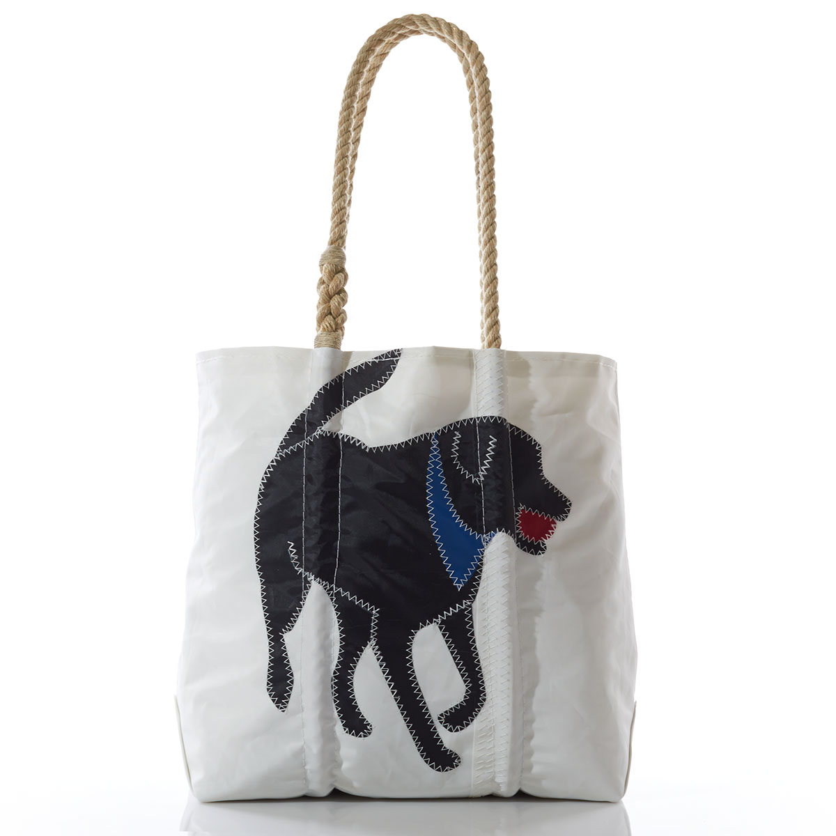 black lab applique with a blue bandana and red ball in his mouth on the front of a recycled sail cloth tote with hemp rope handles