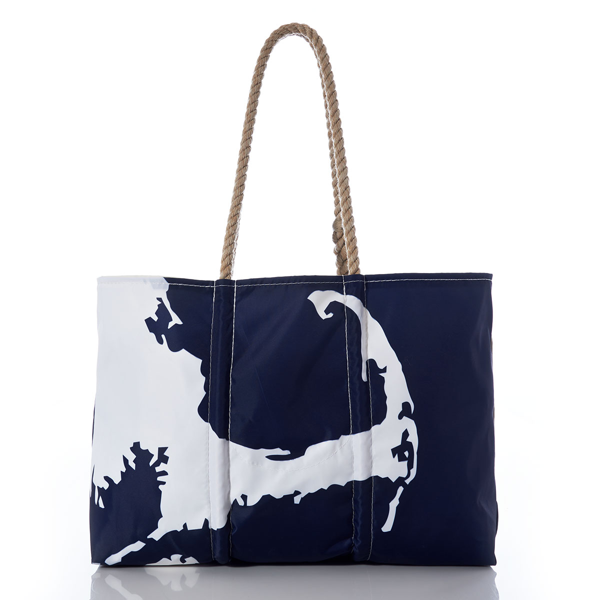 back view of a recycled sail cloth tote with hemp handles is printed with a navy ocean next to a white coastline of Cape Cod