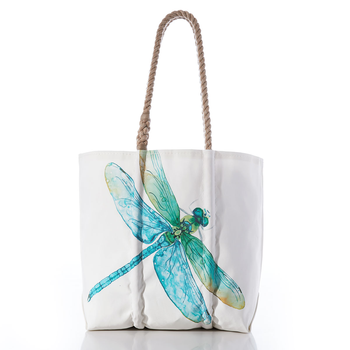 a dragonfly in light shades of blues and greens flies across a white recycled sail cloth tote with hemp rope handles