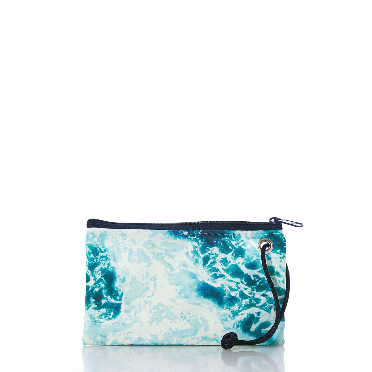 a recycled sail cloth wristlet is printed with a scene of crashing waves upon a shore in bright shades of blue