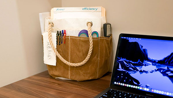 Tan Tool Bucket with office supplies on desk