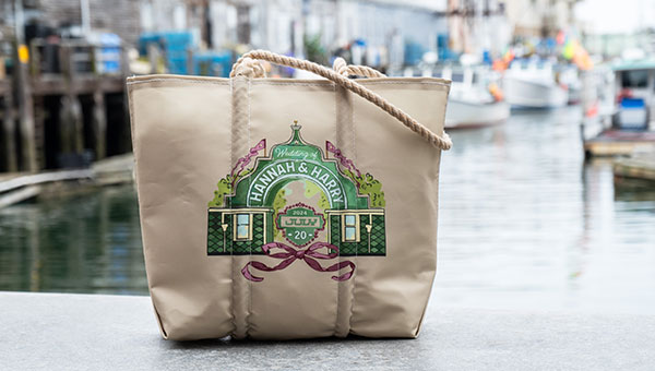 Two dogs sitting in front of a custom dog bag